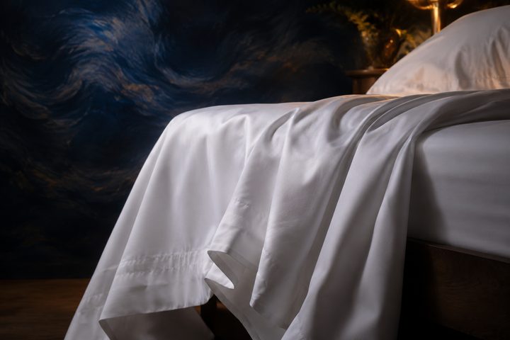 Crisp white sheets draped over a bed